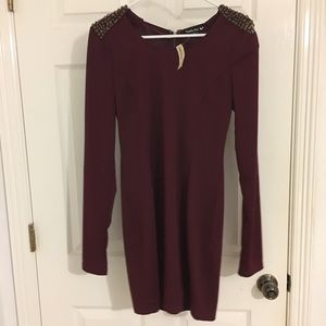 Burgundy dress that is fitted with spike detailing